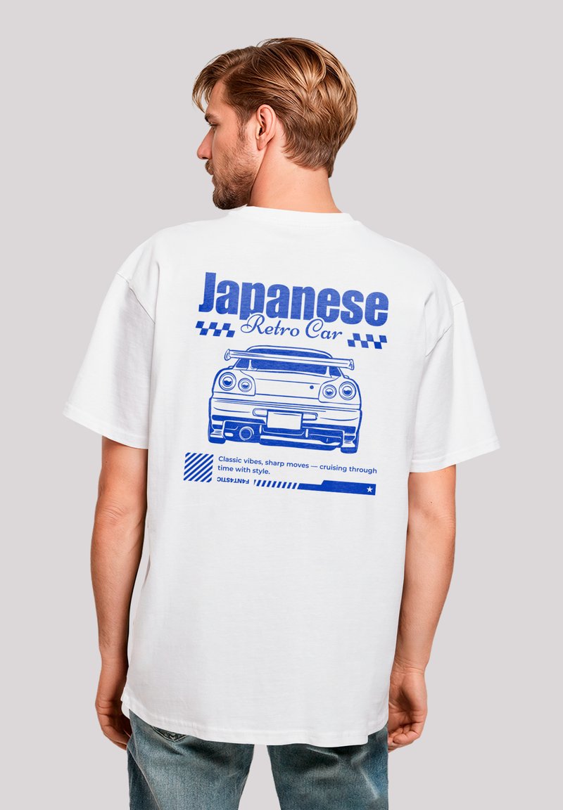 White oversized t-shirt featuring a blue graphic of a retro car on the back with text reading "Japanese Retro Car" and decorative stripes.