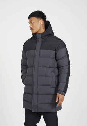 Padded coat in dark gray with a high collar and hood. Features vertical seams, side pockets, and mesh accents on sleeves for breathability.