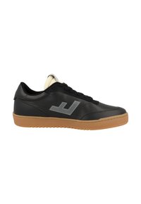 Low-top black leather sneaker with gum rubber sole, black laces, padded beige tongue, and reflective gray logo on side.
