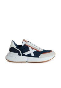 Zapatillas con un upper de tejido azul marino, cordones blancos, acentos naranjas y una suela de goma blanca con un acabado texturizado y detalle de logo.