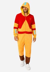 Fleece onesie in red, yellow, and brown, featuring a triangular design, hood with blue arrows, and zip closure. Smooth texture, relaxed fit.