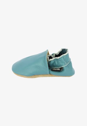 Leather slipper in teal with a soft, textured surface. Features a gathered elastic collar and a tan suede sole for flexibility.