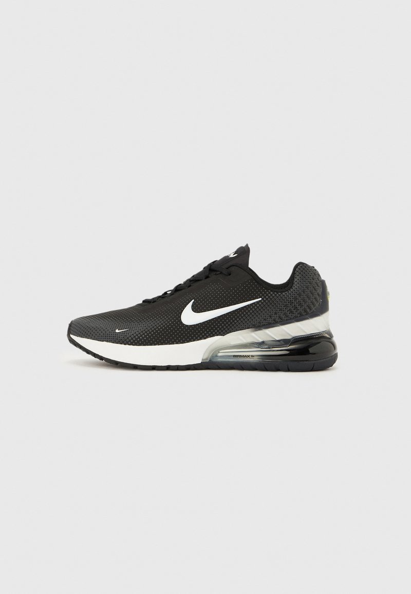 Must Nike Air Max 270 toss sneaker valge Swoosh-logo, valge vahetald ja nähtava õhukummikuga kand, ühetaolise taustaga.