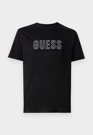 Černé bavlněné tričko s bílým logem "GUESS" a textem "EST 1981 CLASSIC AMERICAN STYLE" pod ním. Krátké rukávy, kulatý výstřih.