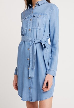 Blue denim shirt dress with long sleeves, button-down front, two chest pockets, and a tied waist belt.