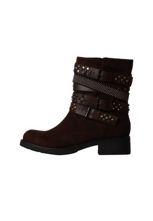 Dark brown suede ankle boot with low heel, featuring three studded leather straps with metal buckles wrapped around the shaft.