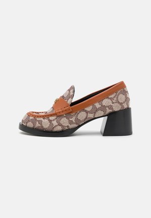 Mocassin à motif marron et beige avec talon épais, garniture en cuir et détail de boucle dorée, présenté de profil sur un fond blanc.