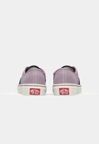 Purple suede shoes with navy accents, white rubber sole, and red logo detail. Designed for casual wear, featuring a low-top silhouette.