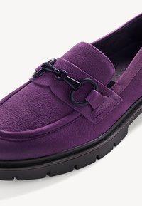 Purple leather loafer with textured finish, a black hardware accent, and a thick black rubber sole. Features a flat, rounded toe design.
