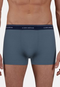 Men's boxers in a dark blue color, made from soft cotton, featuring a contrasting navy elastic waistband with the brand name "ceceba."
