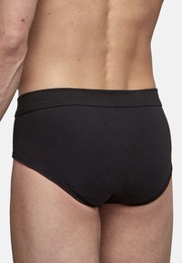 Black cotton underwear featuring a smooth, elastic waistband and a fitted design, showcasing a simple and classic style.