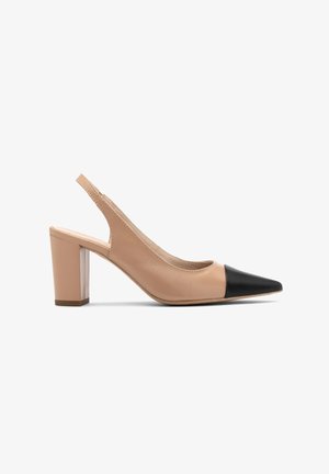 Beige leather slingback heels with a black pointed cap toe. Block heel with a slight texture, featuring a rounded cutout design.