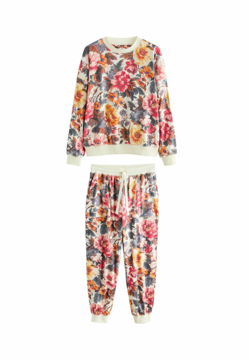 Completo felpa e pantaloni jogger con stampa floreale, caratterizzato da vivaci fiori rossi, gialli e blu su uno sfondo crema. Tessuto morbido, polsini e vita elasticizzati.