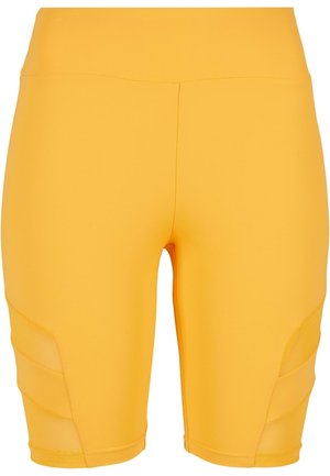Kollased jalgrattashortsid, mis on valmistatud venivast kangast, omavad siledat tekstuuri ja külgedel on võrkpaneelid, mis tagavad lisaventilatsiooni.