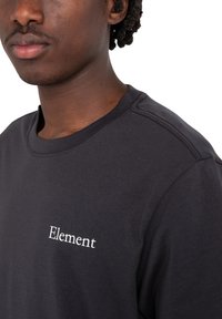 Black cotton t-shirt featuring a crew neck and short sleeves, with "Element" embroidered in white on the chest. Smooth texture.