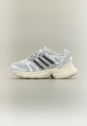 White and silver athletic sneaker with mesh upper, black stripes on the side, and thick cushioned sole on a neutral background.