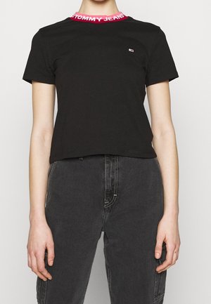 Black cotton t-shirt with a cropped cut, featuring a vibrant pink and red "TOMMY JEANS" logo collar and a small logo on the chest.