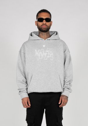 Gray hooded sweatshirt with a front pocket, featuring white graphic text. Model wears black cargo pants and dark sunglasses.