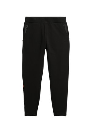 Pantaloni jogger neri con gamba affusolata, vita elastica e tasche con zip; presenta un logo sottile arancione sul lato.