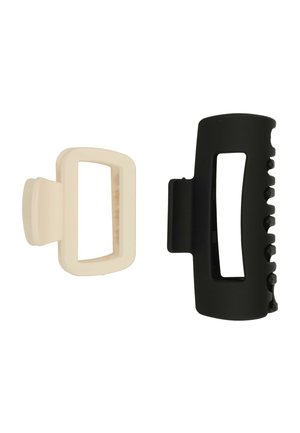 Due mollette per capelli rettangolari affiancate, una beige e una nera, con centri aperti e denti per afferrare i capelli.