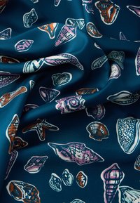 Patterned fabric featuring various illustrated seashells in colors like purple, orange, and white against a dark blue background. Smooth texture.
