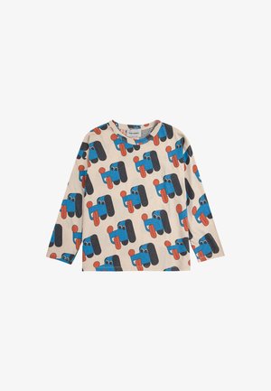 Langärmliges, hellbeiges Hemd mit einem verspielten Muster von cartoonhaften blauen Hunden mit roten Zungen und schwarzen Akzenten. Hergestellt aus weichem Stoff.