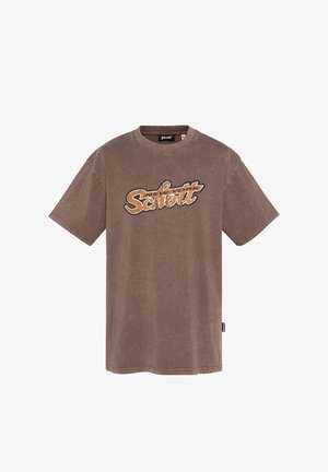T-shirt marron en coton à manches courtes avec le logo « New York Schott » en orange et noir sur la poitrine, col rond et petite étiquette latérale.
