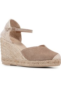 Brown suede espadrille wedge with woven beige accent; ankle strap with buckle; jute-wrapped heel; rounded toe; textured upper.
