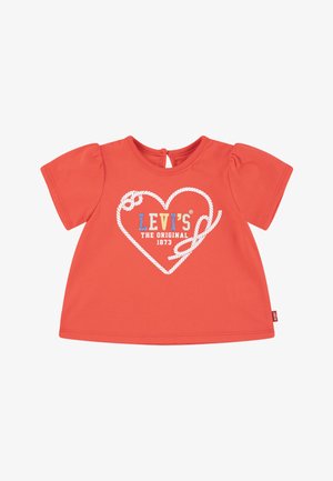 Camiseta de algodón roja con mangas cortas abullonadas y apertura en la parte posterior. Presenta un diseño de corazón con cuerda blanca y texto multicolor "LEVI'S".