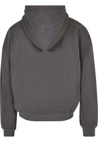 Felpa grigia corta con cappuccio, realizzata in materiale morbido. Presenta polsini e orlo a coste, con una texture liscia e dettagli minimi.