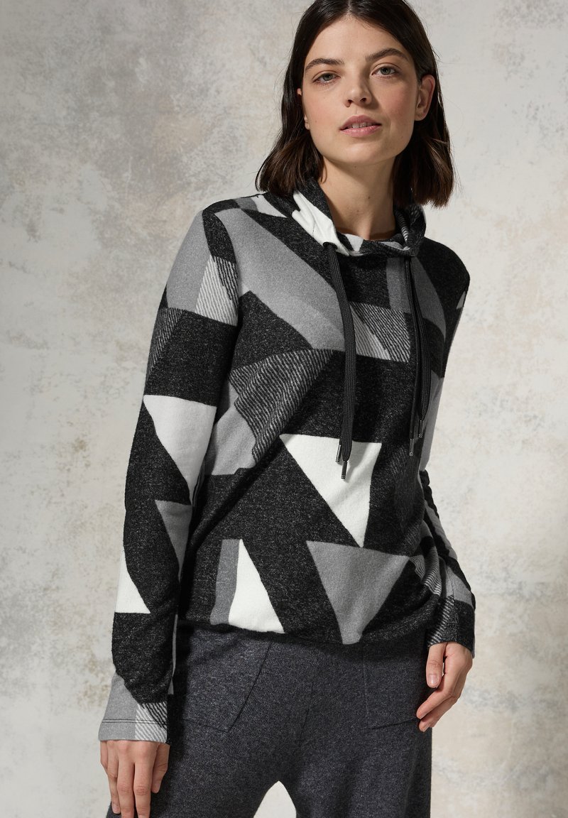 Felpa con cappuccio realizzata in tessuto che presenta audaci motivi geometrici in nero, bianco e grigio, con tasche laterali e cordini regolabili.
