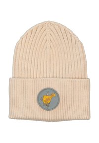 Ribbed, cream-colored beanie with a folded cuff yang menampilkan patch bulat dengan gambar sapi kuning di latar belakang abu-abu.