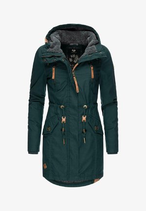 Donkerblauwe parka jas met een met nepbont gevoerde capuchon, twee ritszakken op de borst, verstelbare trekkoorden en tan lederen accenten.