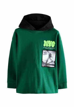 Grön bomullshuvtröja med en svart inre huva, prydd med en stor "NYC"-grafik och en rektangulär fickgrafik av en skateboardåkare.