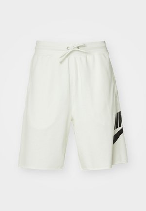 Pantalones cortos de algodón gris claro con una cinturilla elástica, cordón ajustable y un logo negro de Nike en el lado izquierdo.