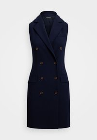 Marineblauw dubbelzijdig vestjurk van gladde stof met grote bruine knopen, met uitgesneden revers en twee voorzakken. Getailleerde silhouet.