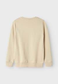 Sudadera de algodón beige con mangas largas, escote redondo, puños de canalé y un acabado ligeramente texturizado, vista desde la espalda.