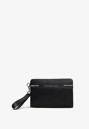 Pochette bracelet noire Tommy Hilfiger en tissu texturé, avec sangle pour poignet et bande avec logo sur le panneau avant supérieur.