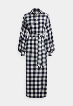 Φόρεμα πουκάμισο με μακριά μανίκια, σε σχέδιο καρό μπλε σκούρο και λευκό, με ζώνη στη μέση και γιακά.