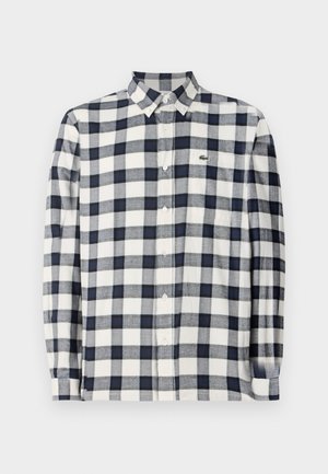Checkered long-sleeve shirt in navy blue and white, made of soft fabric, featuring a button-down collar and a small logo on the chest.