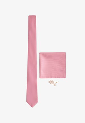 Rosa Seidenkrawatte, passendes Einstecktuch und kleine weiße Blumen-Anstecknadel auf weißem Hintergrund angeordnet.