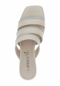 Beige slide sandal with three wide straps, two featuring shiny silver accents. Square toe and soft textured insole with brand name detailing.