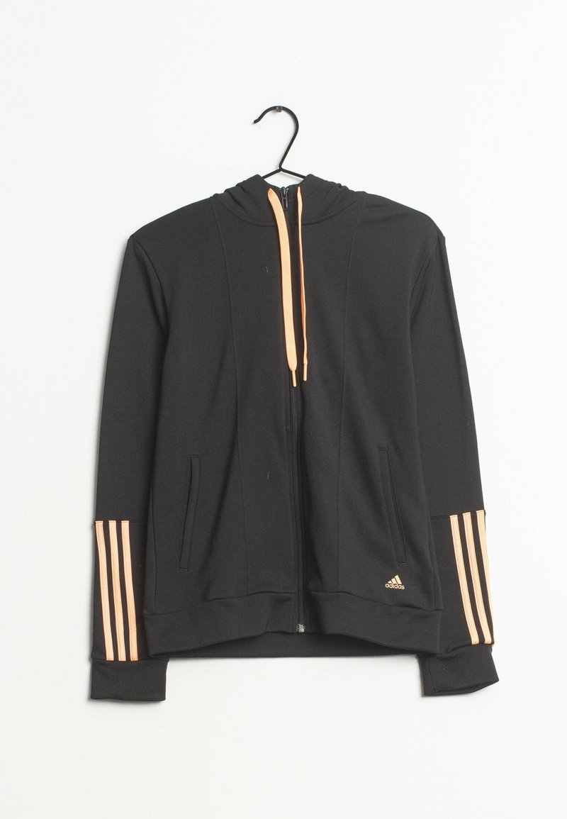 Sweat à capuche noir avec fermeture éclair, cordons de serrage pêche et trois bandes pêche sur les manches, suspendu à un cintre noir sur fond blanc.