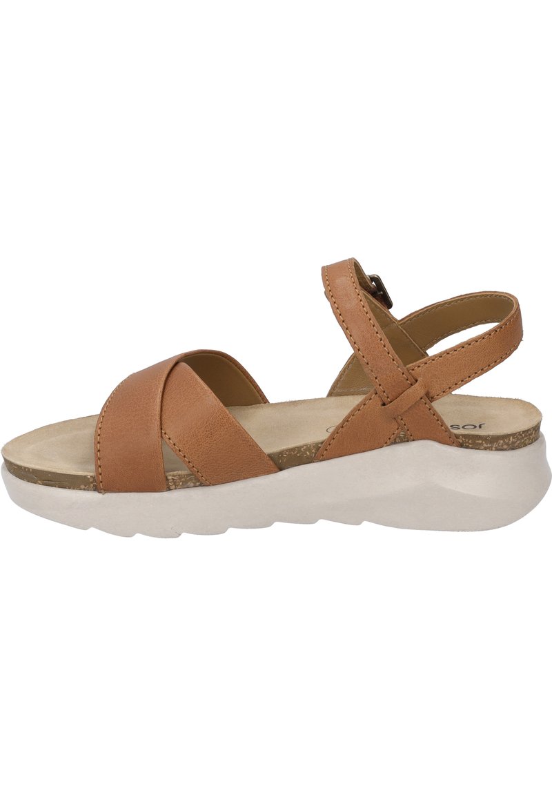 Brown leather sandal with crisscross straps, adjustable buckle, cushioned footbed, and white textured sole. Flat profile and casual design.