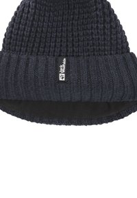 Dark blue knitted beanie with a ribbed cuff. Features a smooth inner lining and a black logo tag on the side. Textured finish.
