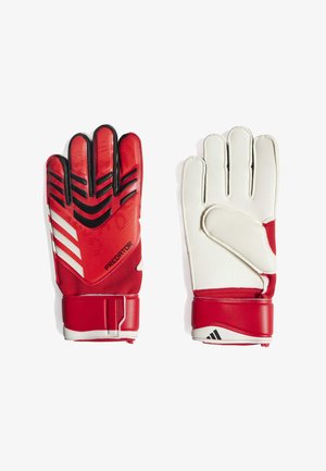 Gants de gardien rouges et blancs avec une prise texturée, présentant un motif en zigzag audacieux, une sangle de poignet réglable et un matériau rembourré.