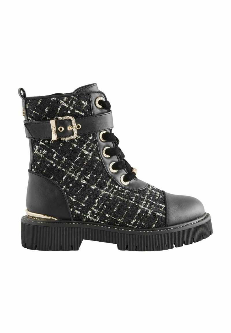Stivaletto nero in tweed con lacci frontali, dettagli in fibbia, suola in gomma e dettagli metallici. Presenta un tessuto testurizzato e elementi in pelle liscia.