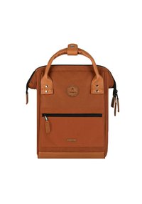 Brown canvas backpack with leather accents, rounded top handle, front zip pocket, and logo patch. Features a sleek, rectangular design.