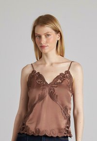 Camisón de seda en color marrón con intrincados bordados en el escote y el dobladillo, con finas tirantes ajustables y una textura suave.