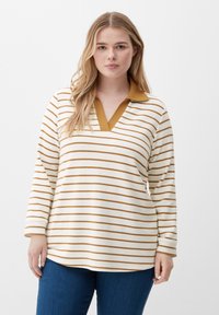 Striped long-sleeve polo shirt in cream and gold, featuring a V-neck and contrasting collar. Soft texture, relaxed fit.